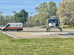 Picture of a Helicopter leaving a helipad with a patient